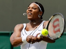 Serena Williams of the US returns a shot to Romania's Simona Halep during their match at the All England Lawn Tennis Championships at Wimbledon, Thursday, June 23, 2011. (AP Photo/Alastair Grant)