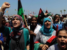 School students chant slogans against Moammar Gadhafi, during a demonstration, at the court square in the rebel-held capital Benghazi, Libya, Saturday, June 25, 2011. (AP Photo/Hassan Ammar)