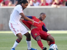 Toronto FC forward Javier Martina, left, knocks Real Salt Lake midfielder Collen Warner off balance during the first half of an MLS soccer game Saturday, June 25, 2011, in Sandy, Utah. Salt Lake defeated Toronto 3-1. (AP Photo/Colin Braley)