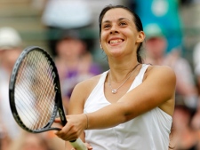 France's Marion Bartoli smiles after defeating Serena Williams of the US in their match at the All England Lawn Tennis Championships at Wimbledon, Monday, June 27, 2011. (AP Photo/Anja Niedringhaus)