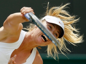 Russia's Maria Sharapova serves to China's Peng Shuai during their match at the All England Lawn Tennis Championships at Wimbledon, Monday, June 27, 2011. (AP Photo/Alastair Grant)