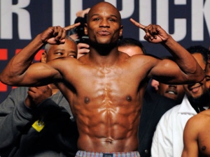 In this April 30, 2010 file photo, Floyd Mayweather Jr. steps on the scale at a weigh-in ceremony before a WBA welterweight boxing title fight against Shane Mosley in Las Vegas. Mayweather, the undefeated six-time world champion, says on his Twitter feed Tuesday, June 7, 2011, he will end a 16-month hiatus from boxing when he faces WBC welterweight champion Victor Ortiz on September 17. (AP Photo/Mark J. Terrill)