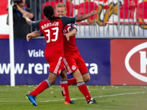 Toronto FC 's Nick Soolsma (right) celebrates with teammate Javier Martina after scoring from the penalty spot against Vancouver Whitecap's during second half MLS action in Toronto on Wednesday June 29, 2011. (THE CANADIAN PRESS/Chris Young)