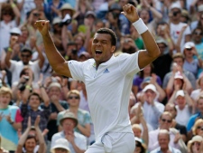 France's Jo-Wilfried Tsonga celebrates defeating Switzerland's Roger Federer in their match at the All England Lawn Tennis Championships at Wimbledon, Wednesday, June 29, 2011. (AP Photo/Alastair Grant)