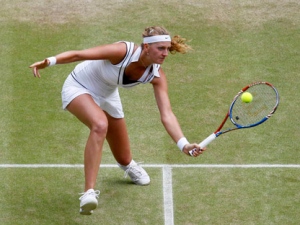 Petra Kvitova of the Czech Republic returns a shot to Victoria Azarenka of Belarus during their semifinal match at the All England Lawn Tennis Championships at Wimbledon, Thursday, June 30, 2011. (AP Photo/Alastair Grant, Pool)