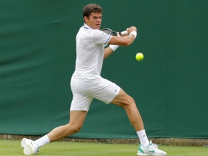 Canada's Milos Raonic plays a return shot to Tunisia's Marc Gicquel at the All England Lawn Tennis Championships at Wimbledon, Monday, 20 June, 2011. (AP Photo/Anja Niedringhaus)