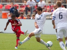 Toronto FC 's Joao Plata (left) shoots as Vancouver Whitecaps' Michael Boxall (centre) and Jay DeMerit close in during first half Nutrilite Canadian Championship final second leg action in Toronto on Saturday July 2, 2011. (THE CANADIAN PRESS/Chris Young)