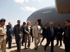 Canada's Minister of Foreign Affairs John Baird, center, arrives at Benina airport in Benghazi, Libya, Monday, June 27, 2011. Others are unidentified. International judges ordered the arrest of Moammar Gadhafi on Monday for murdering civilians, as NATO warplanes pounded his Tripoli compound and world leaders stepped up calls for the Libyan leader to end his four-decade rule.(AP Photo/Hassan Ammar)