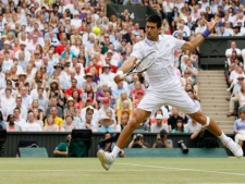 Serbia's Novak Djokovic returns a shot to Spain's Rafael Nadal during the men's singles final at the All England Lawn Tennis Championships at Wimbledon, Sunday, July 3, 2011. (AP Photo/Kirsty Wigglesworth)