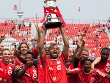 Toronto FC 's captain Maicon Santos lifts the trophy after beating Vancouver Whitecaps' 2-1 to win Nutrilite Canadian Championship in Toronto on Saturday July 2, 2011. (THE CANADIAN PRESS/Chris Young)