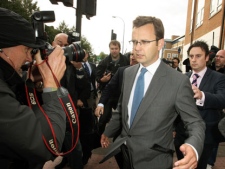 Former Downing Street communication chief Andy Coulson surrounded by media as he leaves Lewisham police station in south London, after being arrested in a phone hacking and police corruption scandal, Friday July 8, 2011. Coulson, British Prime Minister David Cameron's former communications chief and Clive Goodman,an ex-royal reporter for the News of the World tabloid were arrested Friday, the latest to be swept up in a scandal over phone hacking and bribing police that has already toppled a newspaper and rattled the relationship between top politicians and the powerful Murdoch media empire. (AP Photo/PA, Dominic Lipinski)