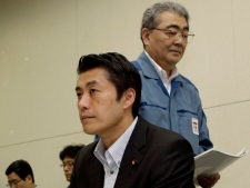 Toshio Nishizawa, president of Tokyo Electric Power Co., walks past Goshi Hosono, state minister for conclusion of the nuclear incident, during a joint press conference in Tokyo Tuesday, July 19, 2011. The crippled reactors at its tsunami-damaged Fukushima Dai-ichi nuclear power plant have reached stability more than four months ago after the March 11 disaster, they said. Officials describing progress at the plant said radiation around the tsunami-crippled plant has decreased from peak levels. (AP Photo/Shuji Kajiyama)