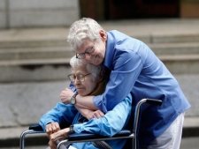 Phyllis Siegel, 76, left, and Connie Kopelov, 84, both of New York, embrace after becoming the first same-sex couple to get married at the Manhattan City Clerk's office, Sunday, July 24, 2011, in New York. (AP Photo/Jason DeCrow)