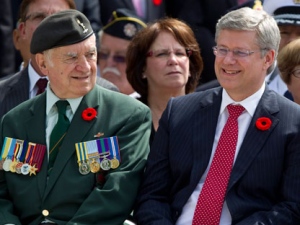 Canadian Prime Minister Stephen Harper (right) sits next to a Korean war veteran as he attends a wreath-laying ceremony at the Korea Veterans National Wall of Remembrance in Brampton, Ontario on Wednesday July 27 2011 . THE CANADIAN PRESS/Chris Young