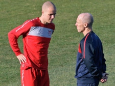 In this Sunday, June 20, 2010 file photo U.S. national soccer coach Bob Bradley, right, speaks to his son, midfielder Michael Bradley during training at Pilditch Stadium in Pretoria, South Africa. (AP Photo/Elise Amendola, File)