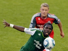 Portland Timbers midfielder Kalif Alhassan, front, chases the ball as Toronto FC's Nick Soolsma defends during the first half of their MLS soccer game in Portland, Ore., Saturday, July 30, 2011. (AP Photo/Don Ryan)