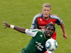 Portland Timbers midfielder Kalif Alhassan, front, chases the ball as Toronto FC's Nick Soolsma defends during the first half of their MLS soccer game in Portland, Ore., Saturday, July 30, 2011. (AP Photo/Don Ryan)