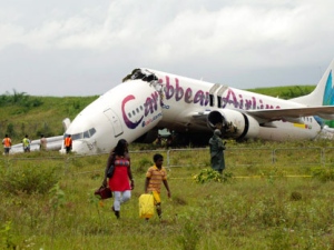 The broken fuselage of a Caribbean Airlines' Boeing 737-800 is seen after it crashed at the end of the runway at Cheddi Jagan International Airport in Timehri, Guyana, Saturday July 30, 2011. The Caribbean Airlines flight 523 from New York touched down on the rainy runway, slid through a chain-link fence and broke apart just short of a ravine but there were no immediate reports of death among the 163 people aboard, despite several dozen of injuries. (AP Photo/Jules Gibson)