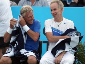 Tennis legends Bjorn Borg, left, of Sweden, and USA�s John McEnroe, speak as they change ends in a men�s doubles exhibition match in Saint Tropez, southern France, Friday, July 8, 2011. (AP Photo/Claude Paris)