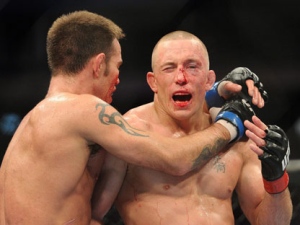 Georges St-Pierre, right, and Jake Shields hug after their welterweight championship match at UFC 129 in Toronto on Saturday, April 30, 2011. St-Pierre defeated Shields in a five-round decision to defend his welterweight title. (THE CANADIAN PRESS/Nathan Denette)