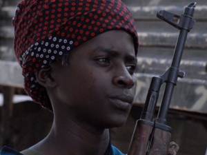 In this photo dated Sunday Feb. 21, 2010, a young boy patrols with other Islamist Al Shabab fighters as they conduct military exercise in northern Mogadishu's Suqaholaha neighborhood, Somalia. (AP Photo/ Farah Abdi Warsameh)