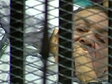 This video image taken from Egyptian State Television shows 83-year-old former Egyptian president Hosni Mubarak laying on a hospital bed inside a cage of mesh and iron bars in a Cairo courtroom Wednesday Aug. 3, 2011.(AP Photo/Egyptian State TV)