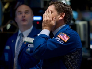 Traders work on the floor of the New York Stock Exchange on Thursday, Aug. 4, 2011 in New York. Stocks are plunging in another broad sell-off as investors grow concerned about an economic slowdown in the U.S. and Europe.(AP Photo/Jin Lee)