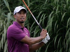 Tiger Woods follows through on the 16th tee during the first round of the Bridgestone Invitational golf tournament Thursday, Aug. 4, 2011, at Firestone Country Club in Akron, Ohio. (AP Photo/Amy Sancetta)