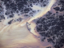 In this Thursday, March 24, 2011 file photo, oil is seen on the creek water's surface near an illegal oil refinery in Ogoniland, outside Port Harcourt, in Nigeria's Delta region. A region of Nigeria's oil-rich southern delta suffers widespread ecological damage as spilled oil seeps into its drinking water, destroys plants and remains in the ground for decades at a time, a United Nations report released Thursday Aug. 4, 2011, shows. The U.N. report focused on the Ogoniland area of Nigeria's Niger Delta, a region of swamps, mangroves and creeks almost the size of South Carolina or Portugal. (AP Photo/Sunday Alamba)