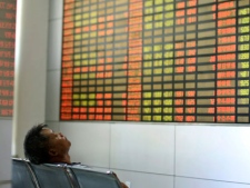 A man takes a nap at a private stock trading company in Shanghai, China, Friday, Aug. 5, 2011. Stocks around the world tumbled Friday ahead of crucial U.S. jobs figures, continuing a losing streak reminiscent of the aftermath of the collapse of U.S. investment bank Lehman Brothers in 2008. (AP Photo)