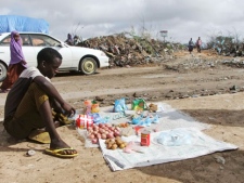 A Somali from southern Somalia sits on the roadside and sells basic necessities during the month of Ramadan, , at a camp for displaced people in Mogadishu, Somalia Saturday, Aug, 6, 2011. (AP Photo/Farah Abdi Warsameh) 