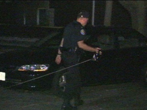 A police officer investigates at the scene of an early morning shootout on Adelaide Street. (CP24)