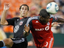 Toronto FC's Andy Iro (3) heads the ball as D.C. United's Josh Wolff, left, defends during the first half of an MLS soccer game Saturday, Aug. 6, 2011, in Washington. The game ended in a 3-3 tie. (AP Photo/Luis M. Alvarez)