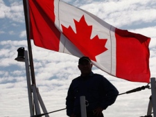 A crew member stands onboard HMCS Vancouver in Esquimalt, B.C., as the ship leaves to support NATO Operations in Libya off the Mediterranean Sea, Sunday July 10, 2011. (THE CANADIAN PRESS/Chad Hipolito)