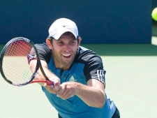 Erik Chvojka from Canada returns the ball to Alexander Dolgopolov from Russia during their first round match at the Rogers Cup tennis tournament in Montreal, Monday, August 8, 2011. (THE CANADIAN PRESS/Graham Hughes)