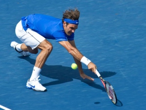 Roger Federer from Switzerland lunges to return to Canada's Vasek Pospisil during second round play at the Rogers Cup tennis tournament Wednesday, August 10, 2011 in Montreal. Federer won 7-5, 6-3. (THE CANADIAN PRESS/Paul Chiasson)