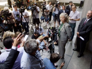 Los Angeles District Attorney spokeswoman Sandi Gibbons, at microphones, talks to reporters after arraignment was postponed for two Southern California men charged with severely beating a San Francisco Giants fan at Dodger Stadium on opening day of this year's baseball season, at the Los Angeles Criminal Justice Center Monday, July 25, 2011. Louis Sanchez, 29, and Marvin Norwood, 30, are accused of mayhem and assault in the March 31 attack on 42-year-old paramedic Bryan Stow, who was beaten into a coma and remains hospitalized. (AP Photo/Reed Saxon)