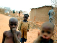 Somali boys walk in the Dagahaley refugee camp north of Dadaab, Eastern Kenya, 100 kms (60 miles) from the Somali border, Thursday Aug. 11, 2011. The United Nations warned Wednesday that the famine in East Africa hasn't peaked and hundreds of thousands of people face imminent starvation and death without a massive global response. About 1,300 new refugees arrive each day in Dadaab camps in northeastern Kenya. The new influx are running away from a famine that is getting worse in southern Somalia as an al-Qaida-linked militants in the country barred some major aid groups from operating in its areas of control, worsening the situation of the most vulnerable people. (AP Photo/Jerome Delay)