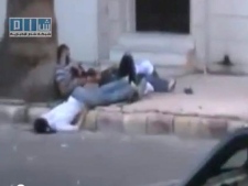 In this image made from amateur video released by Shams News Network and accessed via The Associated Press Television News on Thursday, Aug. 11, 2011, shows dead and injured bodies in the street in Homs Syria Wednesday Aug. 10, 2011. (AP Photo/Shams News Network, via APTN)