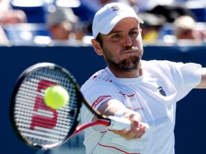 Mardy Fish, of the United States, returns a shot to Ernests Gulbis, of Latvia, during the Farmers Classic tennis tournament final in Los Angeles, Sunday, July 31, 2011. Gulbis won 5-7, 6-4, 6-4. (AP Photo/Danny Moloshok)