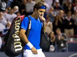 Roger Federer from Switzerland walks off the court after losing to Jo-Wilfried Tsonga from France during round of sixteen play at the Rogers Cup tennis tournament Thursday, August 11, 2011 in Montreal. (THE CANADIAN PRESS/Paul Chiasson)