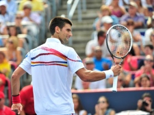 Novak Djokovic, from Serbia, returns to Mardy Fish, from the United States, during the men's final at the Rogers Cup tennis tournament, Sunday Aug. 14, 2011, in Montreal. (THE CANADIAN PRESS/ Paul Chiasson)