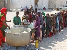 Children from southern Somalia line up to receive cooked food distributed by a local NGO in Mogadishu, Somalia, Thursday, Aug. 18, 2011. Thousands of people have arrived in Mogadishu over the past two weeks seeking assistance and the number is increasing by the day, due to lack of water and food. (AP Photo/Farah Abdi Warsameh)