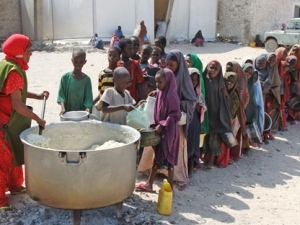 Children from southern Somalia line up to receive cooked food distributed by a local NGO in Mogadishu, Somalia, Thursday, Aug. 18, 2011. Thousands of people have arrived in Mogadishu over the past two weeks seeking assistance and the number is increasing by the day, due to lack of water and food. (AP Photo/Farah Abdi Warsameh)