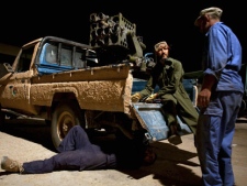 In this Saturday, Aug. 13, 2011 photo, workers modify a civilian pick-up truck into a military vehicle, adding weapons and reinforcements, in Zintan, western Libya. Zintan has become the nerve center of what is emerging as the rebels' most promising front in their campaign to oust Gadhafi: an attempt to flank the grinding deadlock in the center of the country with an assault from the far west.(AP Photo/Giulio Petrocco)