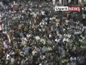 In this image from amateur video made available by the Ugarit News group on Thursday Aug. 18 2011, a large crowd reportedly gathered in the town of Rastan near Homs on Wednesday Aug 17 during which people chant "Rastan demands the execution of the president." They also chanted "He who becomes our enemy we will fight him." "We want to fight Bashar." Syrian President Bashar Assad told the United Nations chief that military operations in his country have ended, even as activists reported more bloodshed overnight . (AP Photo/ Ugarit via APTN)