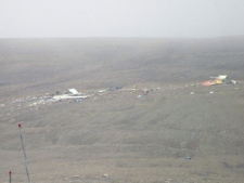 The wreckage of the First Air 737-200 is seen as fog descends on Saturday Aug. 20, 2011 in Resolute Bay, Nunavut. Only three survived the crash after it hit a small hill while trying to land on a runway at Resolute. (THE CANADIAN PRESS/Nicolas Laffont)