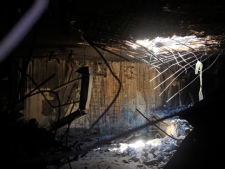 A hole caused by the NATO bombings, is seen in the main Moammar Gadhafi compound in Bab Al-Aziziya in Tripoli, LIbya, Thursday, Aug. 25, 2011. Libya's rebel leadership has offered a 2 million dollar bounty on Gadhafi's head, but the autocrat has refused to surrender as his 42-year regime crumbles, fleeing to an unknown destination. Speaking to a local television channel Wednesday, apparently by phone, Gadhafi vowed from hiding to fight on "until victory or martyrdom." (AP Photo/Sergey Ponomarev)