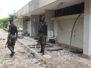 Nigeria police guard at the bombed site of the United Nation's office Sunday, Aug. 28, 2011 after a car bombing on Friday in Abuja, Nigeria which killed at least 19 people. Nigeria's president says his government will bring terrorism "under control". (AP Photo/Sunday Alamba)