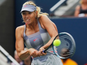 Maria Sharapova of Russia returns a shot to Heather Watson of Britain during the first round of the U.S. Open tennis tournament in New York, Monday, Aug. 29, 2011. Sharapova won 3-6, 7-5, 6-3.(AP Photo/Mike Groll) 